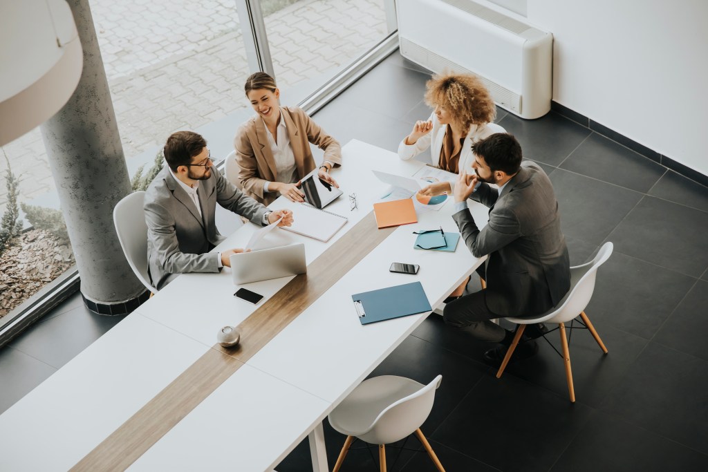 Overhead view at group of multiethnic business people working together in the office