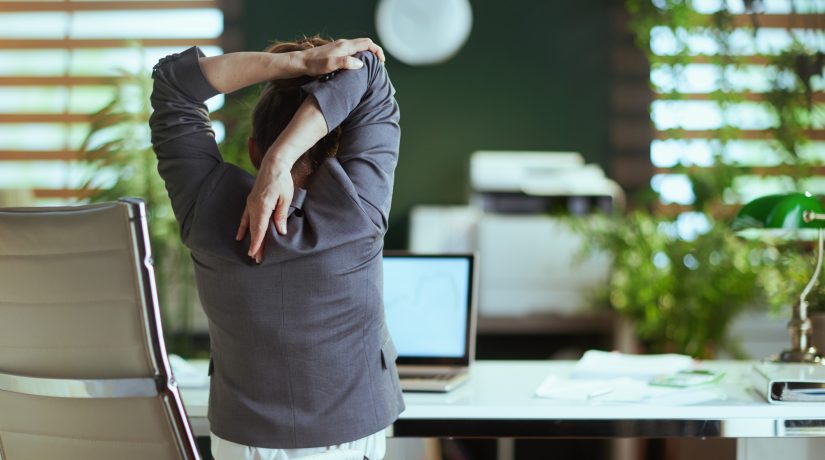 modern business woman in modern green office stretching hand