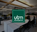 UBM Logo overlayed on a modern office.